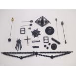 A collection of jet jewellery including brooches, Victorian stick pin set with a pearl, buckles,