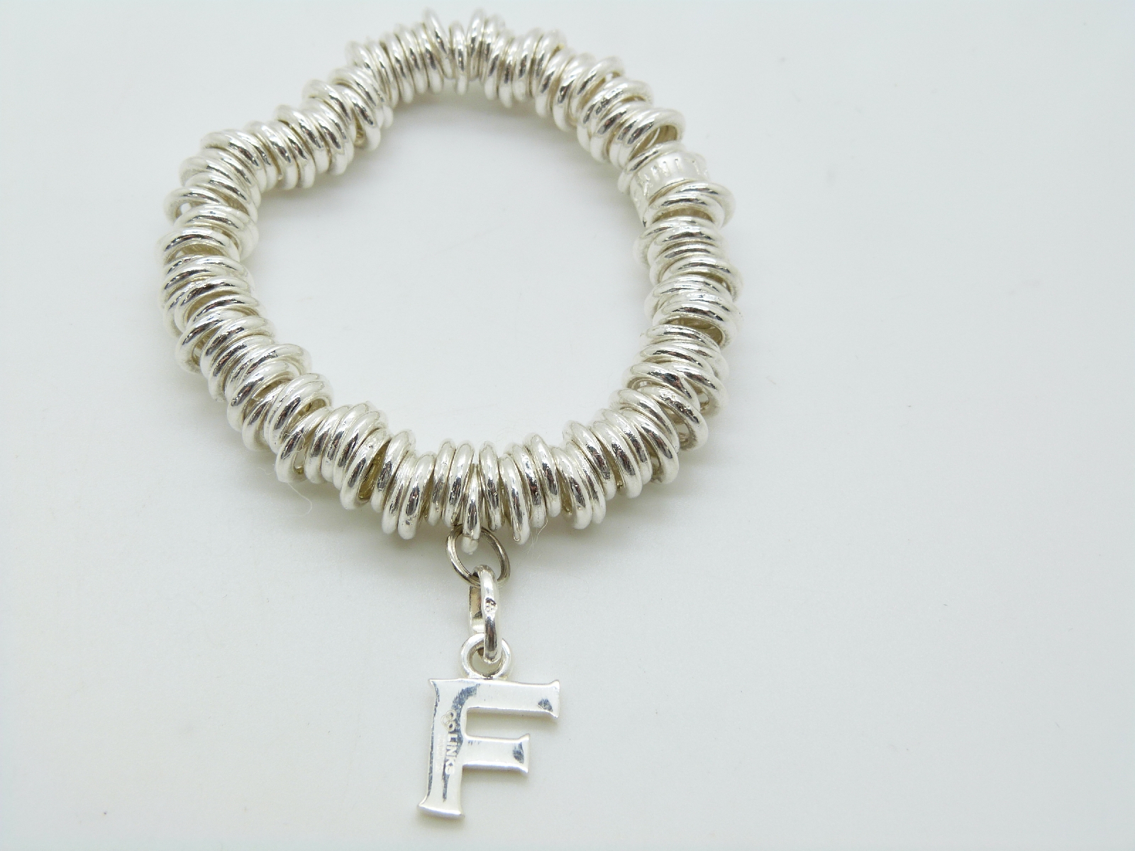 Links of London silver bracelet with letter F charm and a silver bangle set with pressed amber and - Image 4 of 4