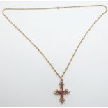A yellow metal cross set with rubies and pearls and a 9ct gold chain, 10.2g