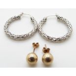 A pair of 9ct white gold earrings and a pair of gold studs, 1.8g