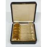 Cased set of 12 Fench gilt white metal teaspoons with French silver mark and indistinct maker's mark