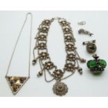 A silver necklace set with tiger's eye and mother of pearl, a silver dolphin brooch set with rubies,