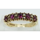 A 9ct gold ring set with rubies and diamonds, size N