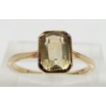 A 9ct gold ring set with an emerald cut citrine, size N