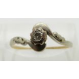 An 18ct gold ring set with a diamond in a platinum setting, size N