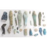 A quantity of Egyptian Shabti figures, amulets, bronze statue part etc