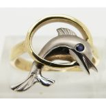 A 14ct gold ring in the form of a dolphin set with a sapphire eye, size L