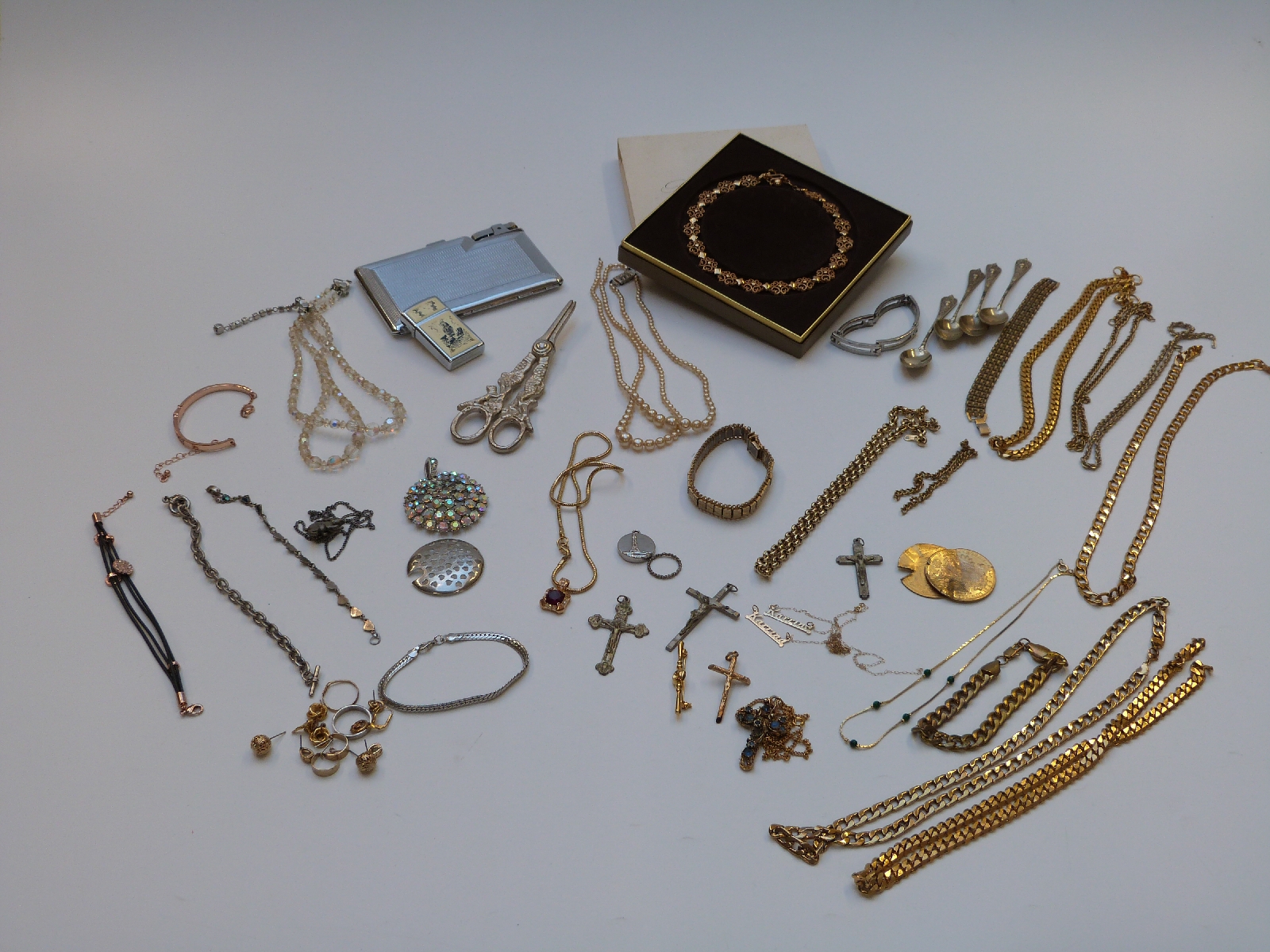 A collection of costume jewellery to include chains, lighter, Avon necklace, 9ct gold necklaces,