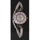 Silver ladies wristwatch with pink guilloché enamel bezel, blue Arabic numerals, silver face,