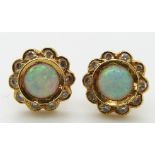 A pair of 18ct gold earrings set with an opal cabochon surrounded by diamonds