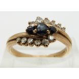 A 9ct gold ring set with sapphires and diamonds in a twist setting, size O