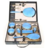 Gentleman's blue guilloché enamel and silver plated dressing table set in leather case, width 30.