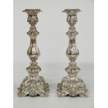 A pair of embossed hollow white metal candlesticks, each only marked 13 in rectangular punch, height