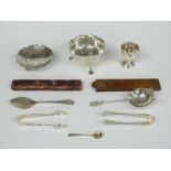 A quantity of hallmarked silver items including sugar bowl, tea strainer, egg cups, sugar tongs