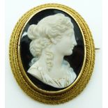 Victorian yellow metal large brooch mounted with an agate cameo of a young woman by Verge, in