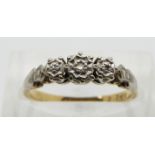 An 18ct gold ring set with three diamonds in a platinum setting, size M