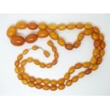 A Baltic amber necklace made up of graduated oval beads, largest bead 2.4 x 1.7cm, smallest 1 x 0.