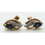 A pair of 9ct gold earrings set with a marquise cut sapphire and diamonds
