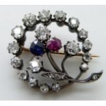 Victorian brooch in the form of a crescent with central flower set with old cut diamonds, the