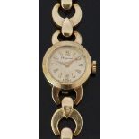 Dugena 14ct gold ladies wristwatch with gold hands and triangular markers, champagne dial and signed