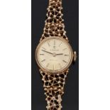 Tissot Stylist 9ct gold ladies wristwatch with two tone hands and baton markers, gold face and