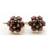 A pair of 18ct gold earrings set with clusters of garnets