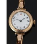 A 9ct gold ladies wristwatch with blued hands, Arabic numerals, white enamel dial and Swiss movement