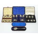 Three cased sets of hallmarked silver spoons including one with tongs and a cased rat tail spoon,