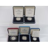 Five cased silver proof commemorative UK coins to include two pounds, one pound and fifty pence