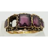 A 15ct gold ring set with garnets, Birmingham 1873, with engraved band, size M