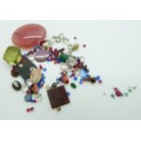 A collection of loose gemstones including a seal, agate, paste, rubies, emeralds, diamonds etc