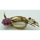 An 18ct gold brooch set with rubies and sapphires, 8.8g