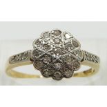 An 18ct gold ring set with diamonds in a platinum setting, size P