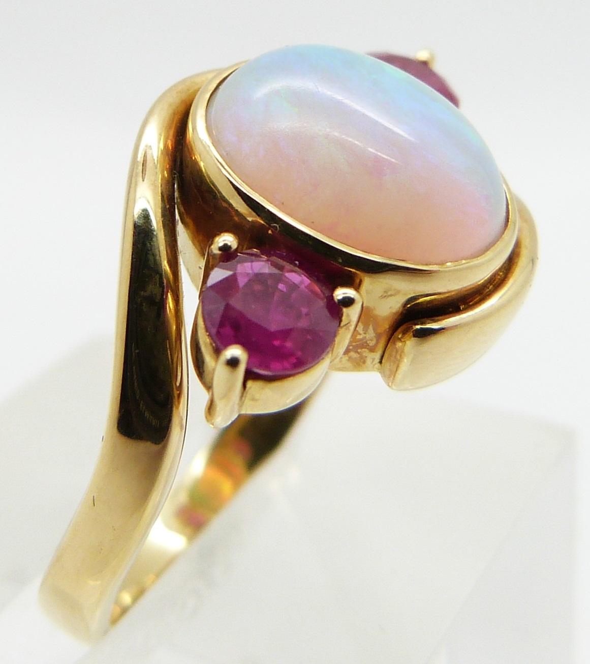 An 18ct gold ring set with an oval opal cabochon and two round cut rubies, size M - Image 2 of 3