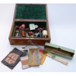 An inlaid marquetry workbox with contents inc vintage bone cotton holder, scissors, needles,