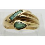 A 14ct gold ring set with emeralds in a stylized snake design, size K/L