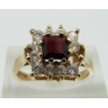 A 9ct gold ring set with a garnet, size O