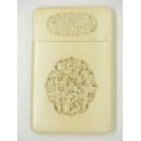 A 19thC Chinese ivory card case with carved cartouches of figures among buildings to both sides,