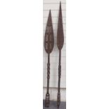 A pair of African carved ceremonial paddles/ spears, length 147cm