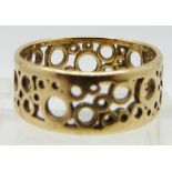An 18ct gold ring with cut out circle design purchased at Hooper Bolton, 3.7g, size O