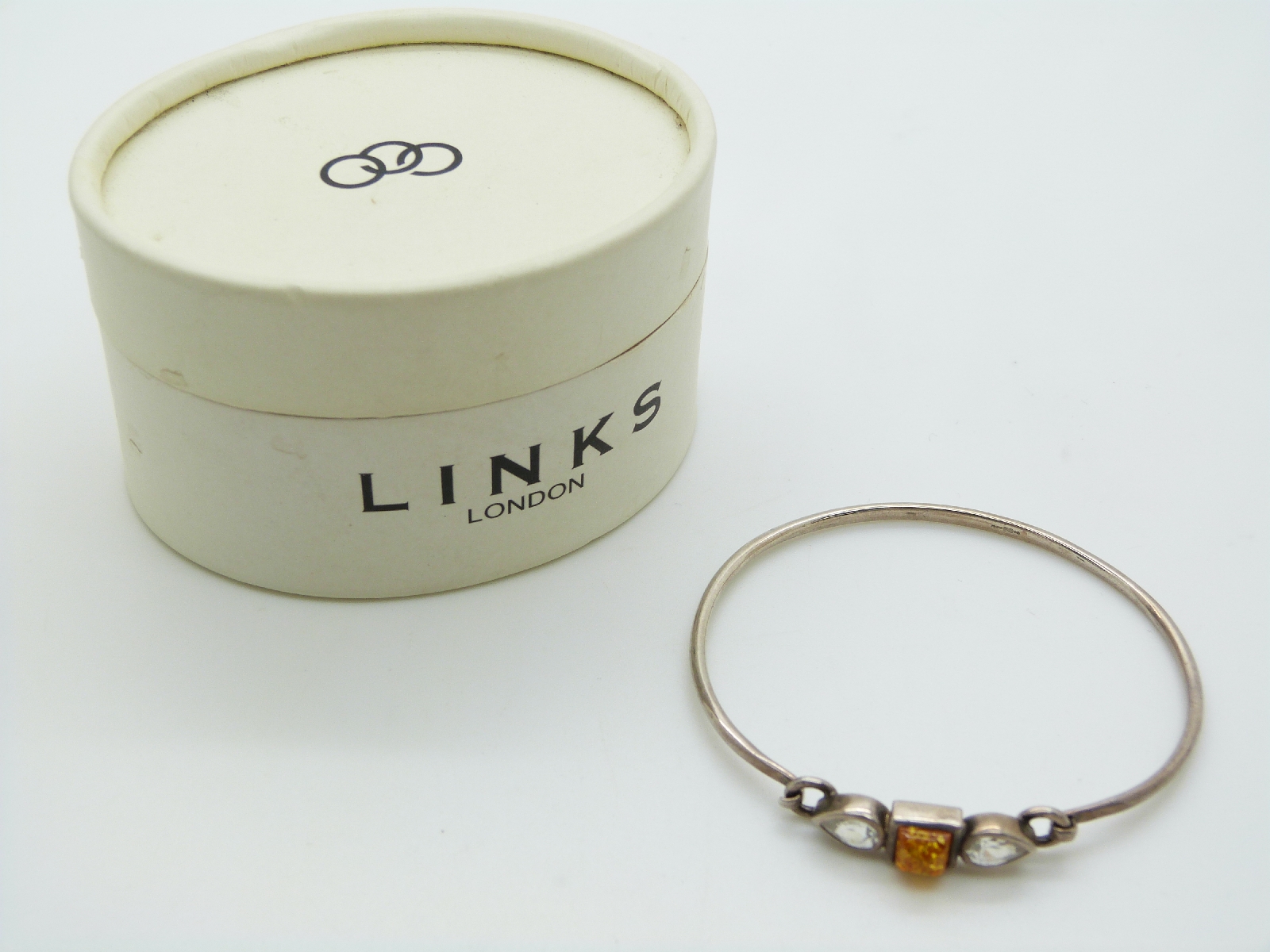 Links of London silver bracelet with letter F charm and a silver bangle set with pressed amber and