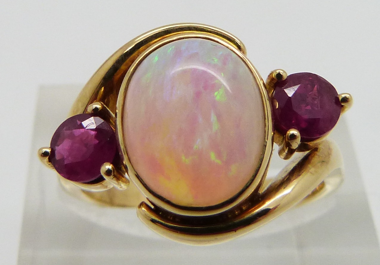 An 18ct gold ring set with an oval opal cabochon and two round cut rubies, size M - Image 3 of 3