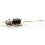 A Victorian stick pin in the form of an insect / beetle set with seed pearls and paste, 9.5cm long