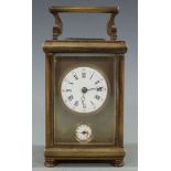 Victorian carriage alarm clock in brass case, with white enamel inset Roman dial for time and Arabic