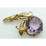 A 9ct gold brooch set with a large amethyst in the form of a bunch of flowers, 7g