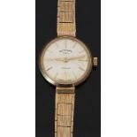 Rotary 9ct gold ladies wristwatch with gold hands and baton markers, silver dial, and signed 21