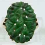 A 9ct gold ring set with a carved jadeite plaque, size L