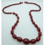 A graduated cherry amber necklace made up of oval beads, 117g