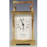 Twentieth century brass carriage clock by Woodford, the white Roman dial with Arabic minutes and