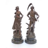 A pair of French bronzed spelter figures of farm workers both with brass plaques to base "